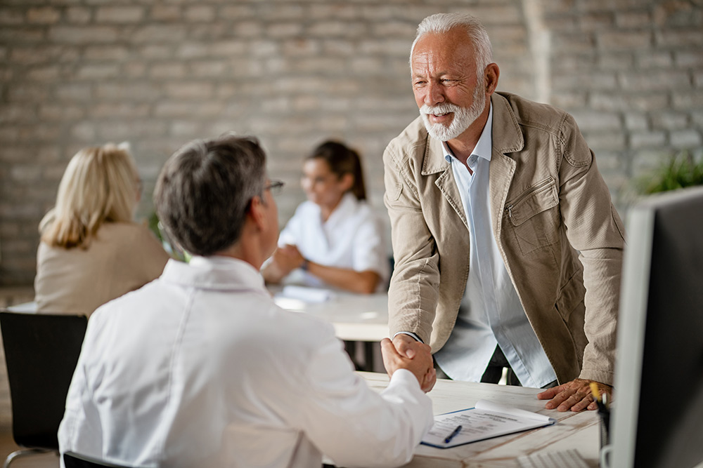 senior man shaking hands with a doctor